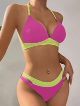 a woman in a pink and green bikini top