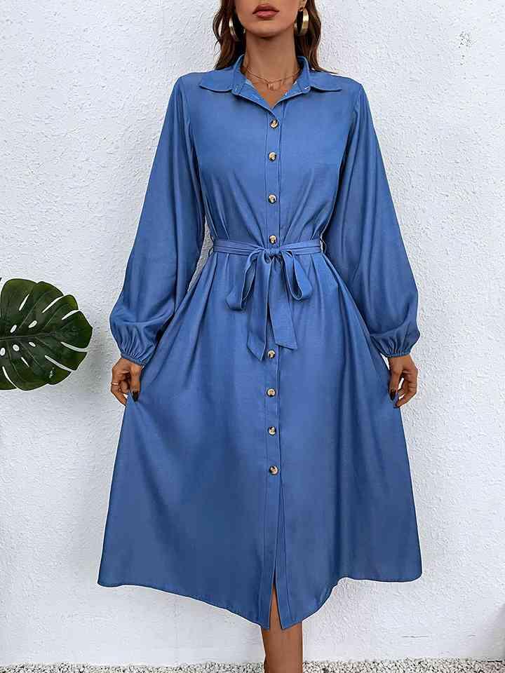 a woman wearing a blue shirt dress