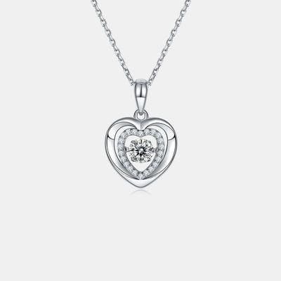 a heart shaped pendant with a diamond center