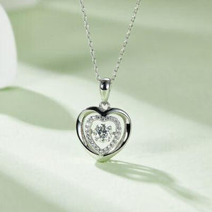 a heart shaped diamond pendant on a chain