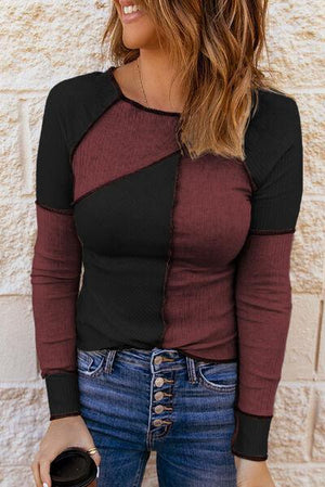 a woman wearing a red and black top