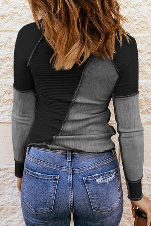 the back of a woman wearing jeans and a black top