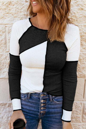 a woman wearing a black and white shirt and jeans