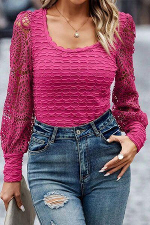 a woman wearing a pink top and ripped jeans