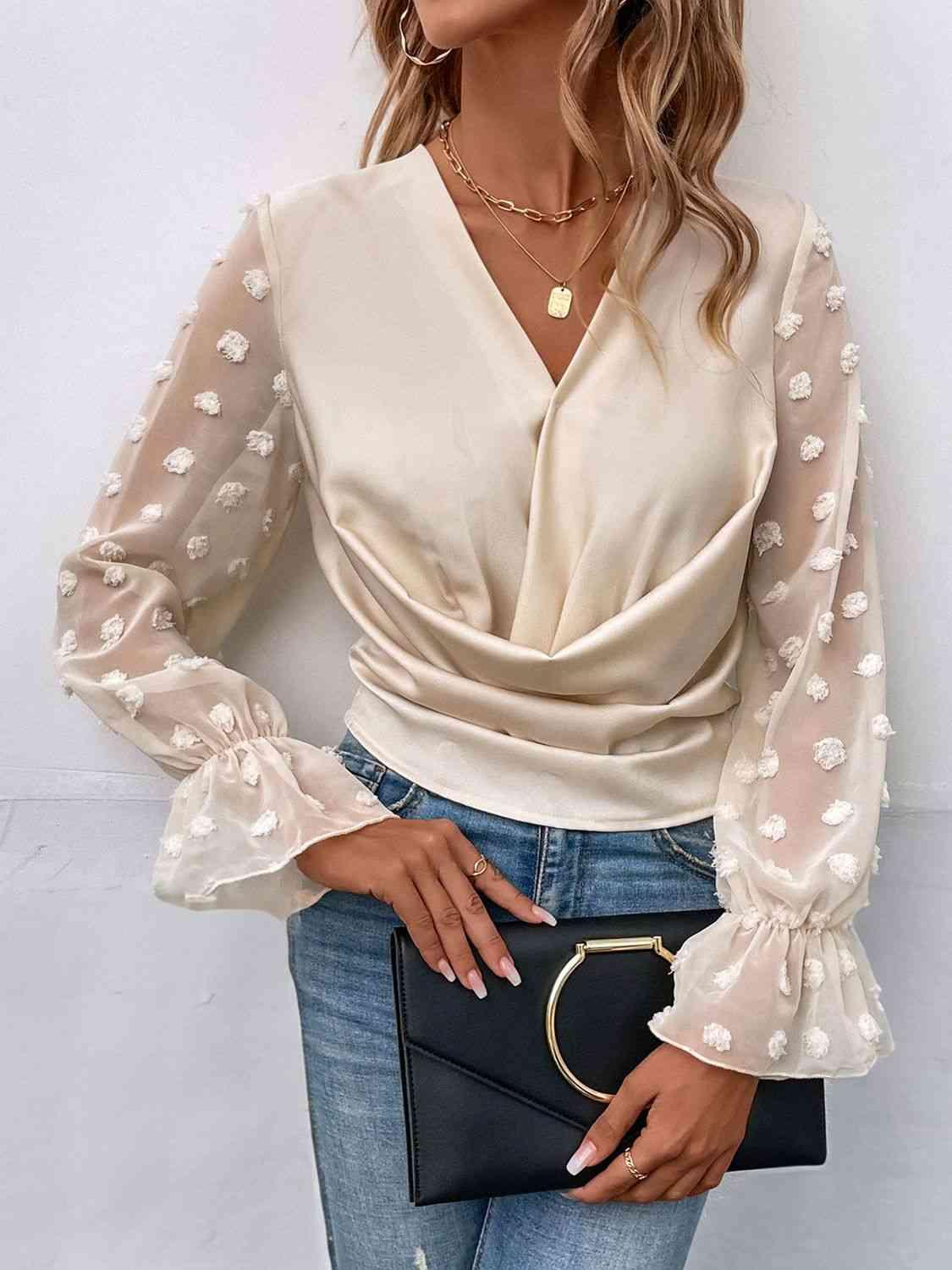 a woman wearing a white blouse and jeans