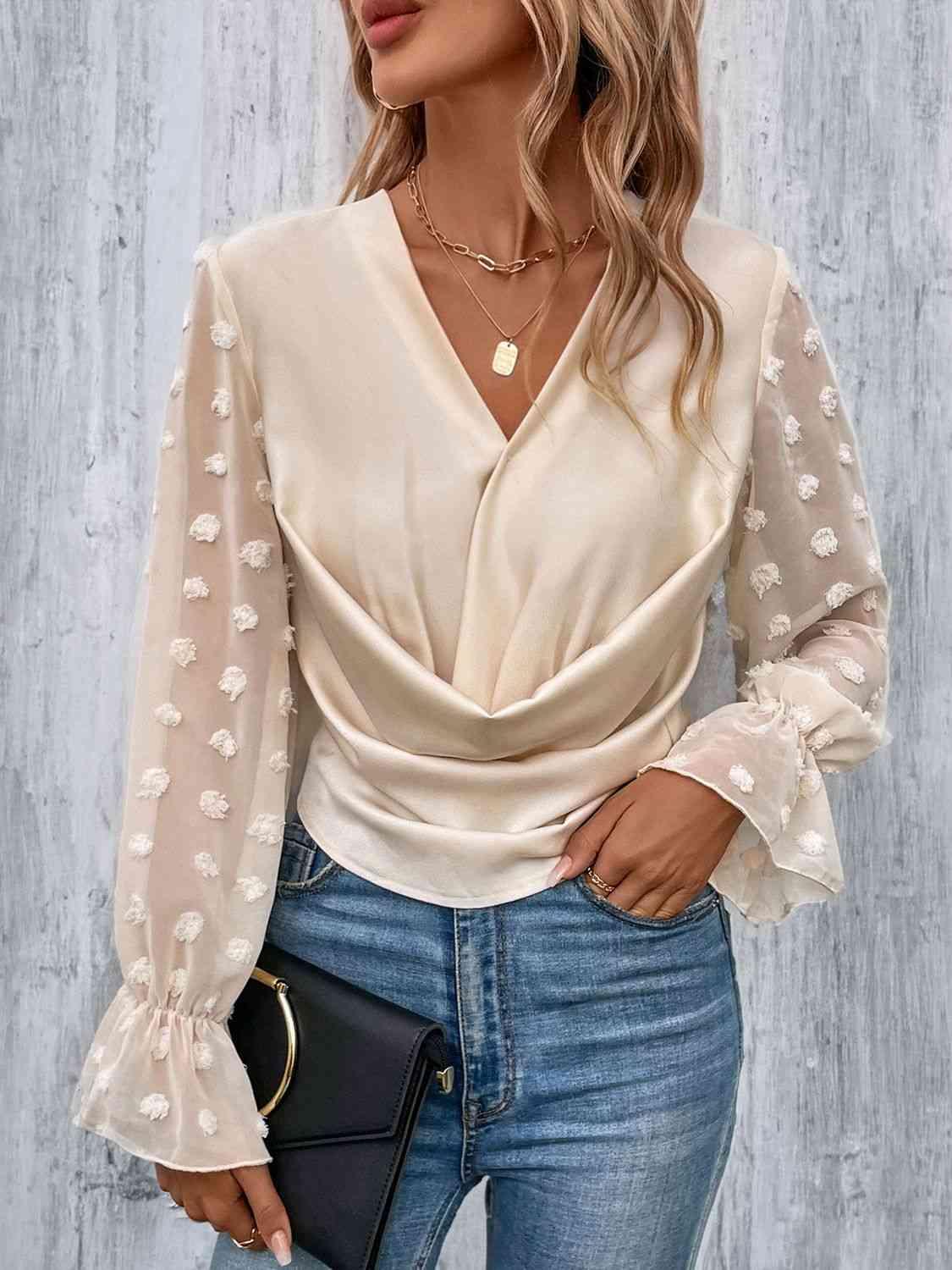 a woman wearing a white blouse and jeans