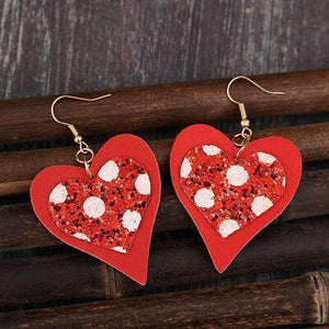 a pair of red and white heart shaped earrings