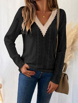 a woman wearing a black sweater and jeans