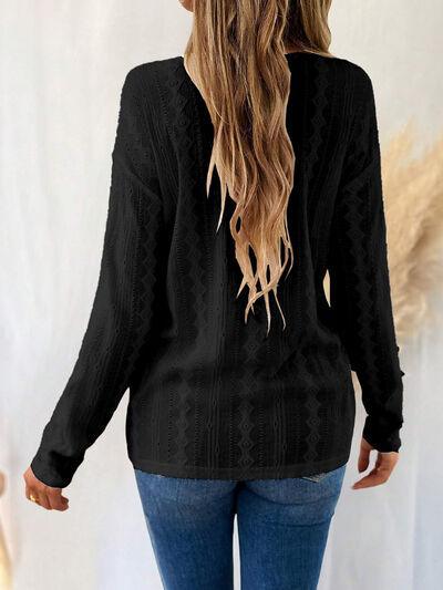 a woman wearing a black sweater and jeans