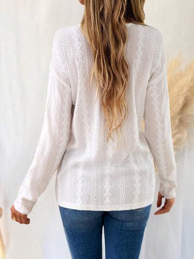 a woman wearing a white sweater and jeans