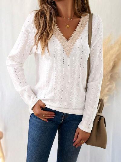 a woman wearing a white sweater and jeans