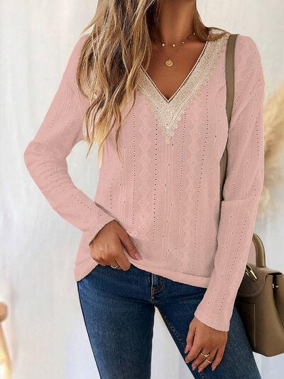 a woman wearing a pink sweater and jeans