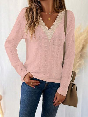 a woman wearing a pink sweater and jeans