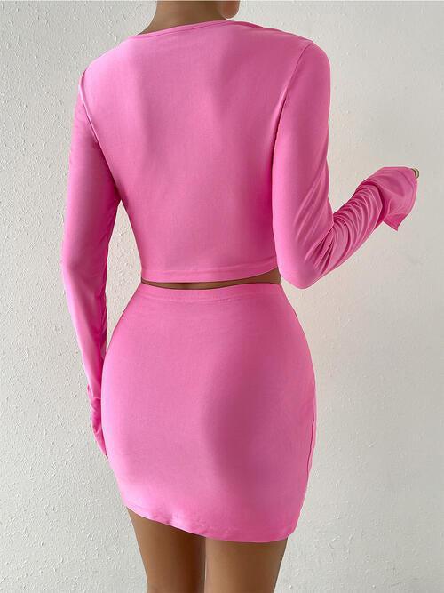 a woman wearing a pink dress with a cut out back