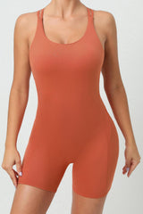 a woman in an orange bodysuit posing for a picture