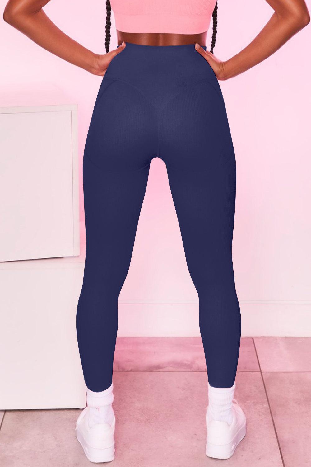 a woman in a pink top and blue leggings