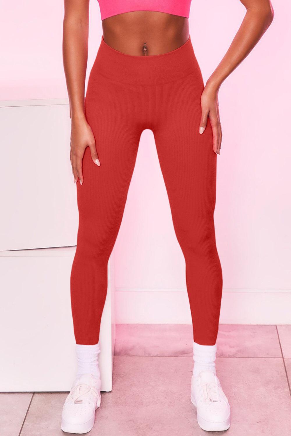 a woman in a pink sports bra top and red leggings