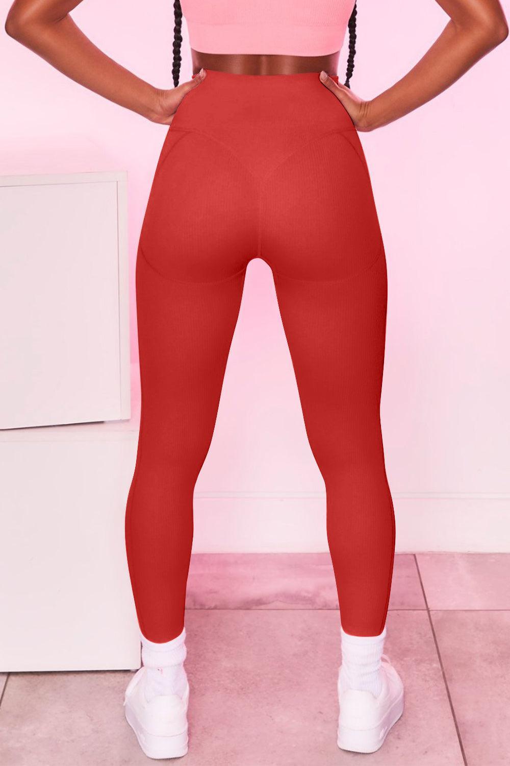 a woman in a pink top and red leggings