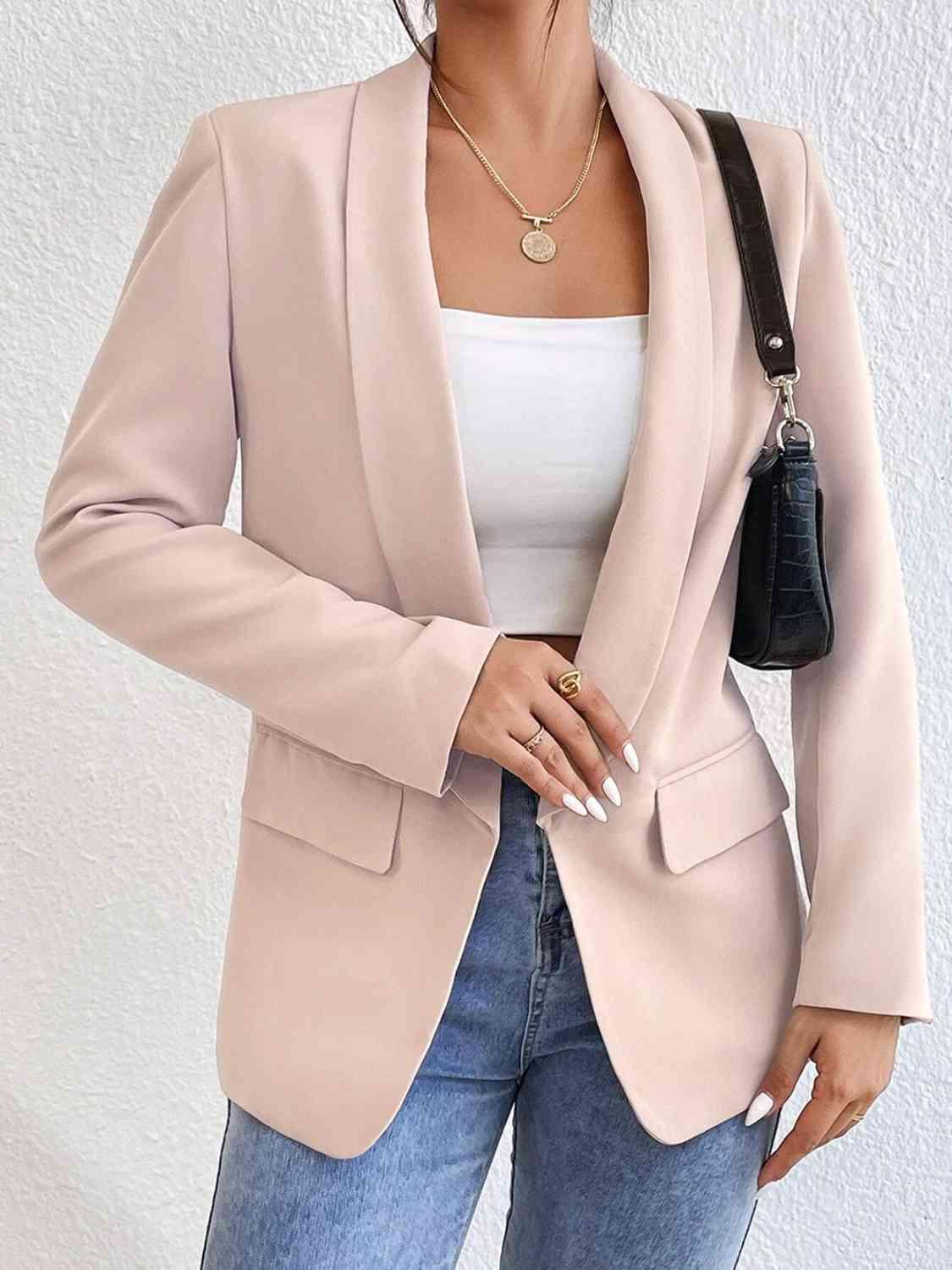 a woman wearing a pink blazer and jeans