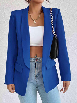 a woman wearing a blue blazer and jeans