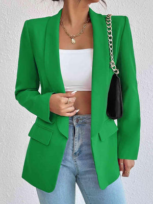 a woman wearing a green blazer and jeans
