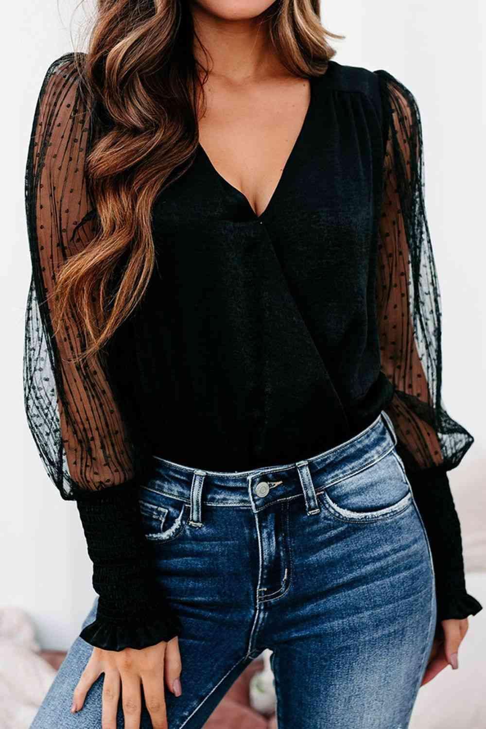 a woman wearing a black top and jeans