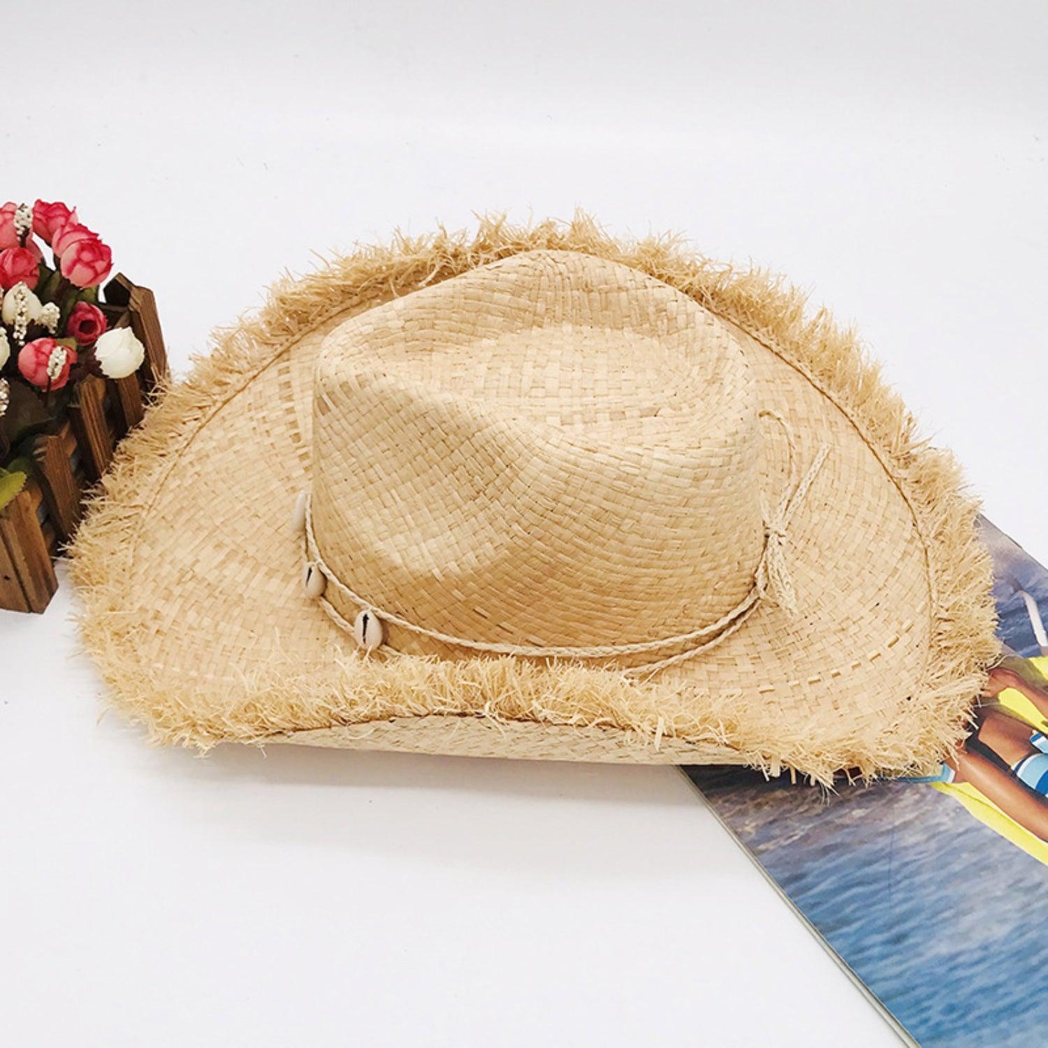 a straw hat sitting on top of a surfboard