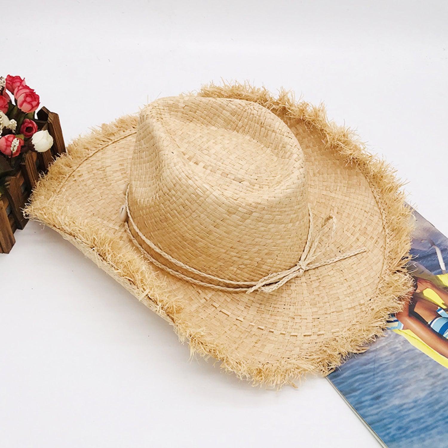 a straw hat sitting on top of a skateboard