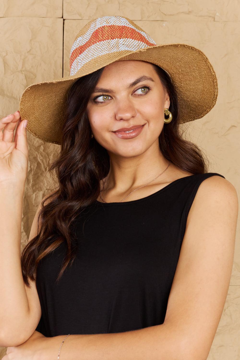 a woman wearing a brown hat and a black top