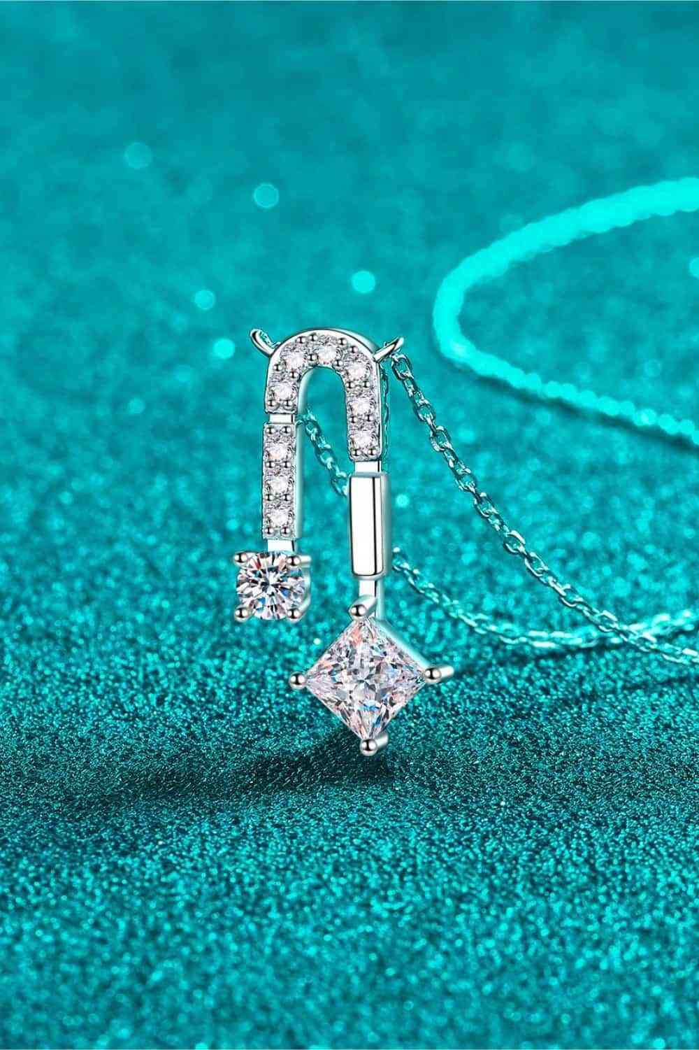 a diamond necklace on a chain on a blue background