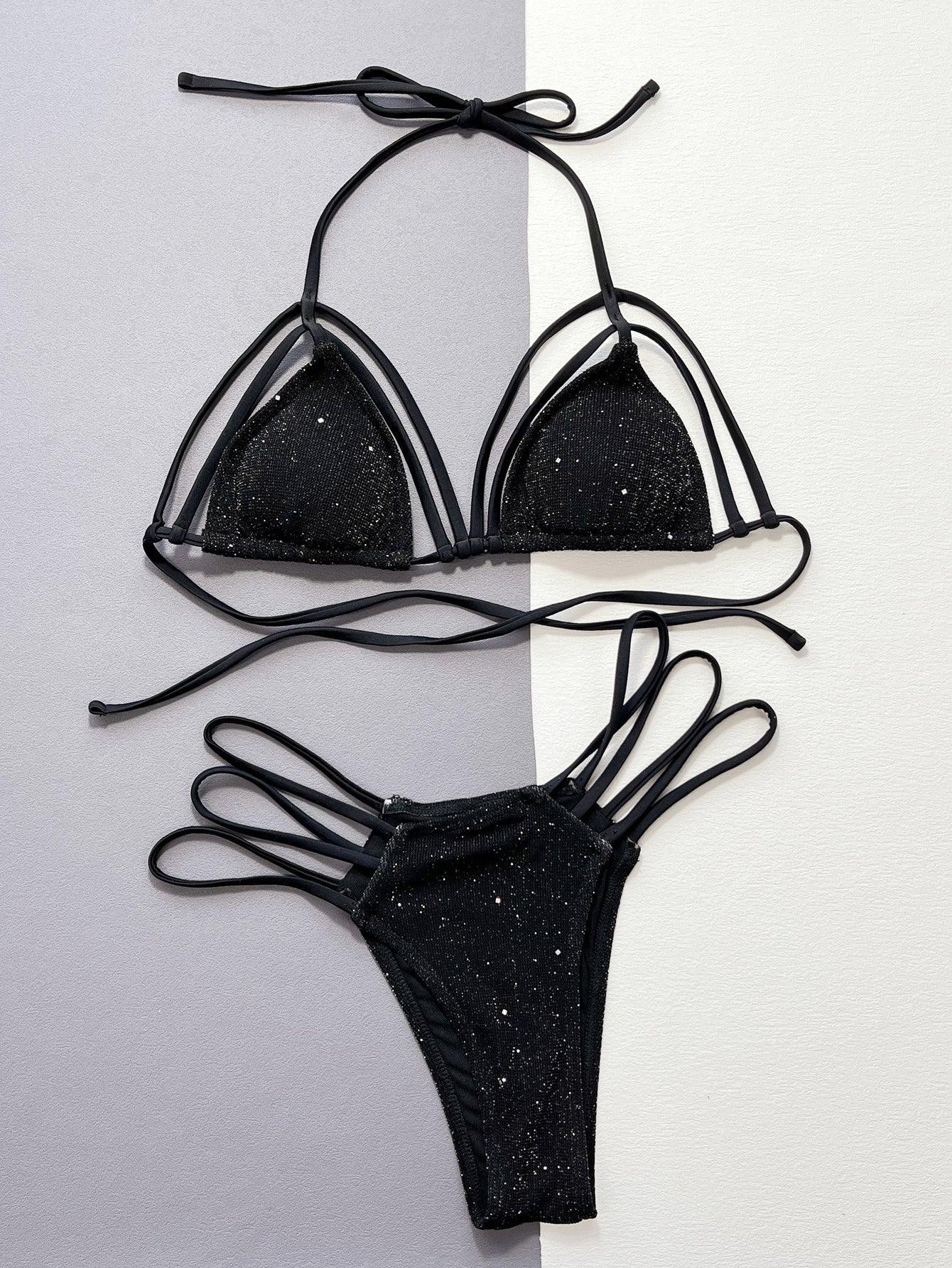 a pair of black bikinis hanging on a wall