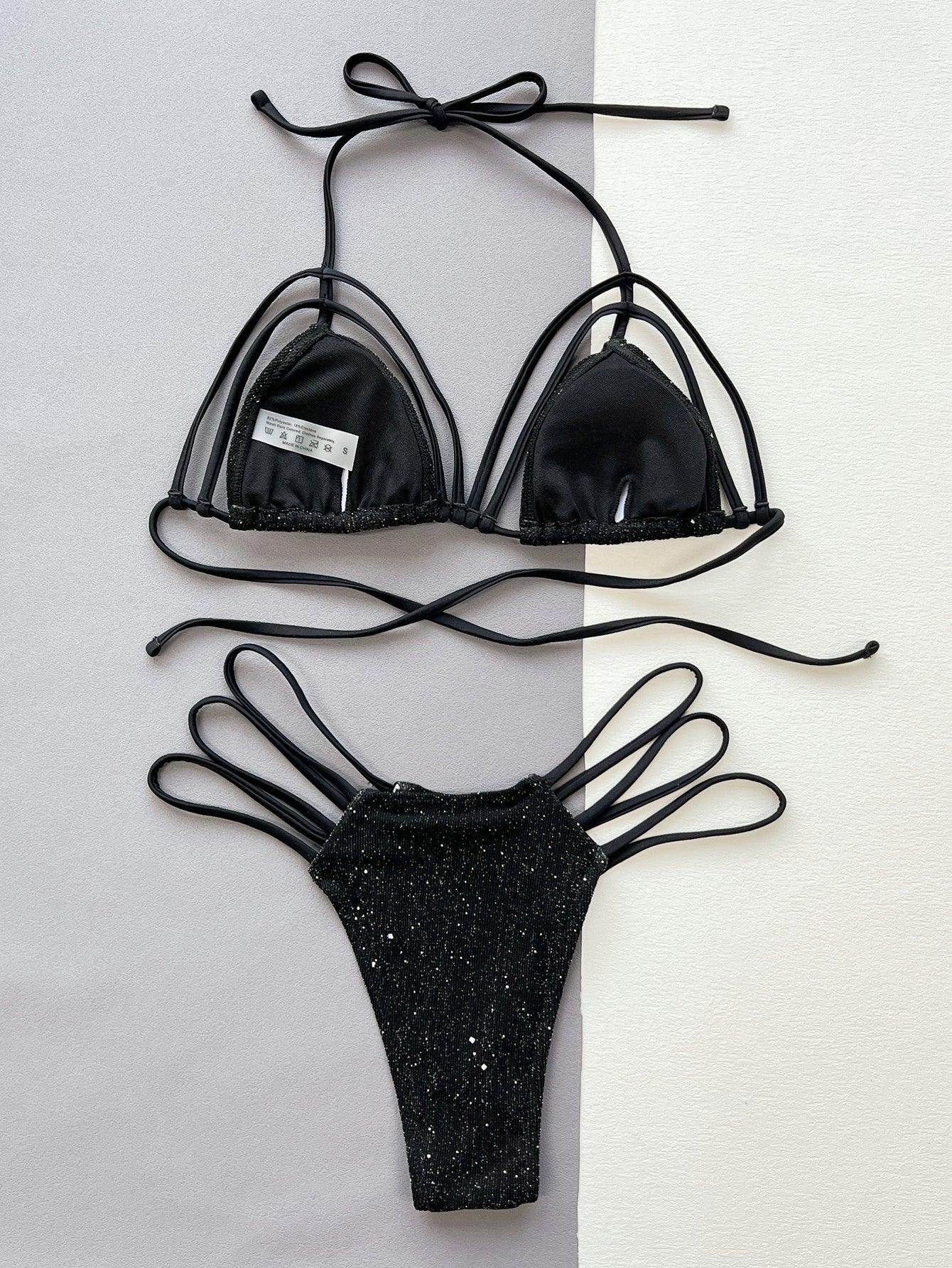 a pair of black bikinisuits hanging on a wall