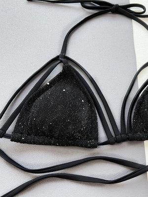 a pair of black bras with straps on a white surface