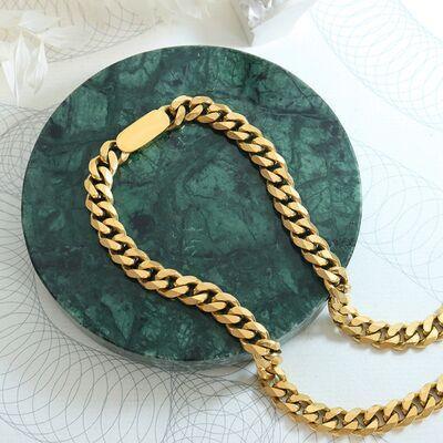 a gold chain on a green marble plate