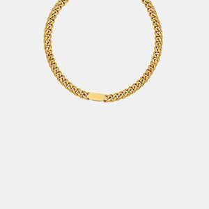 a gold chain bracelet on a white background