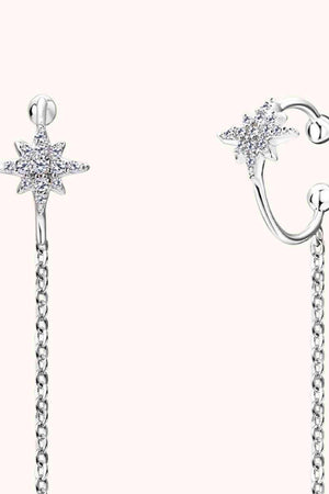 a pair of earrings with a star and a chain