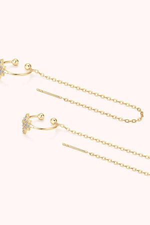 a pair of earrings with a chain attached to it