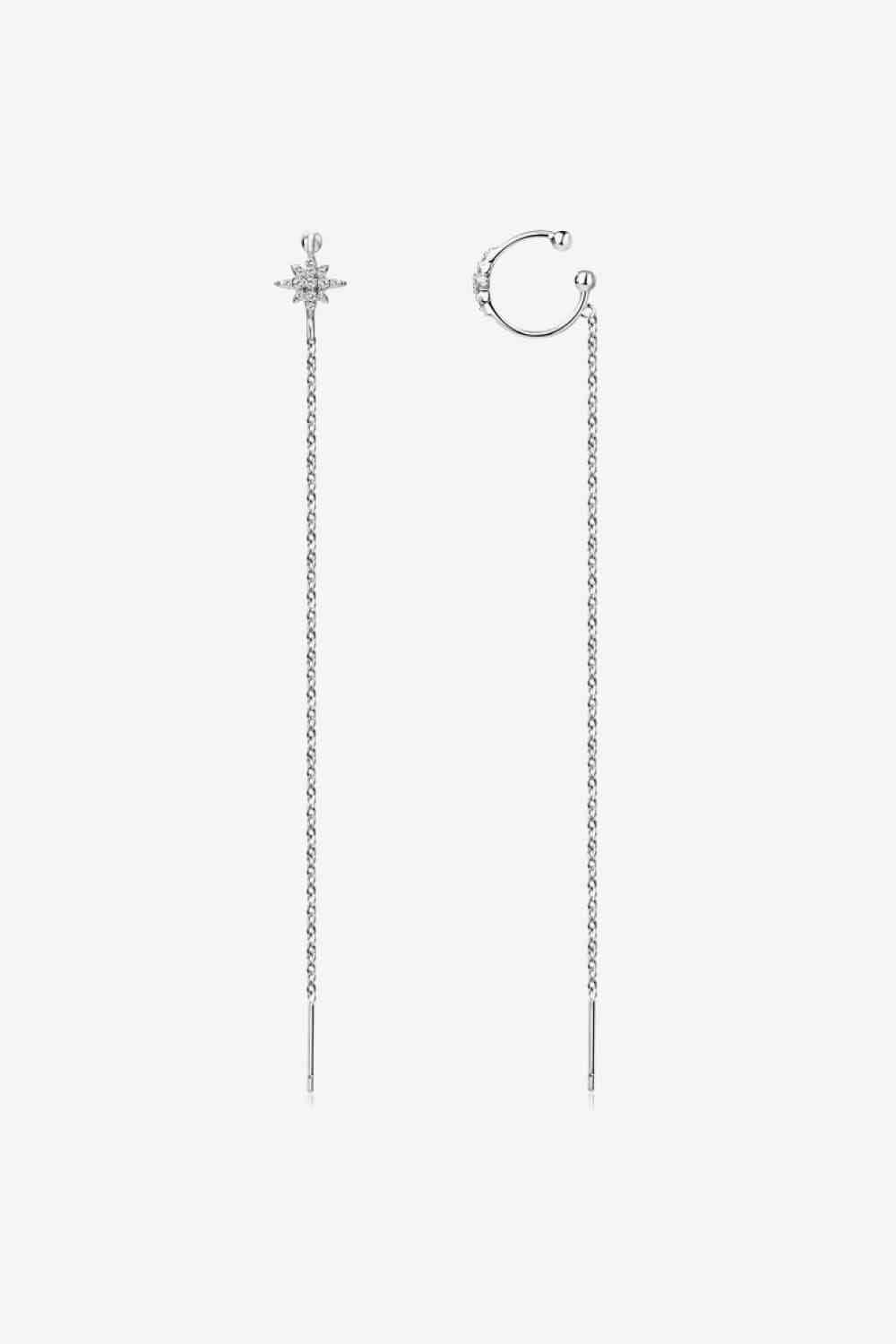 a pair of earrings on a white background