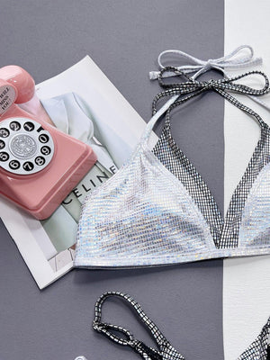 a woman's bikini top with a phone and other items