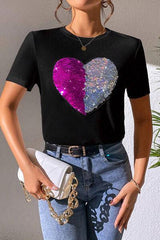 a woman wearing a t - shirt with a heart on it