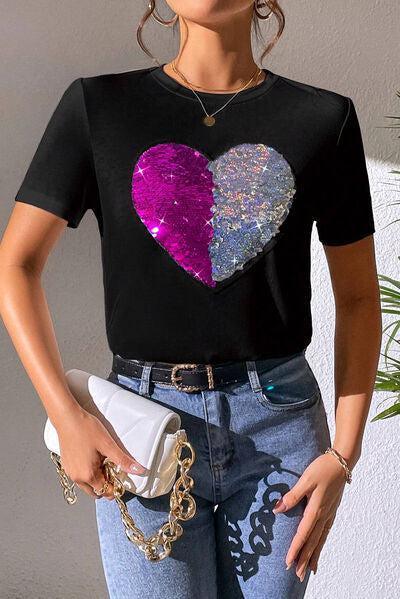 a woman wearing a t - shirt with a heart on it