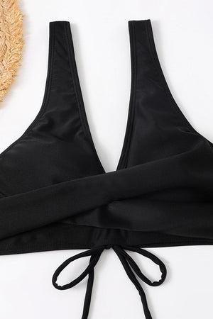 a woman's black bra top with a straw hat next to it