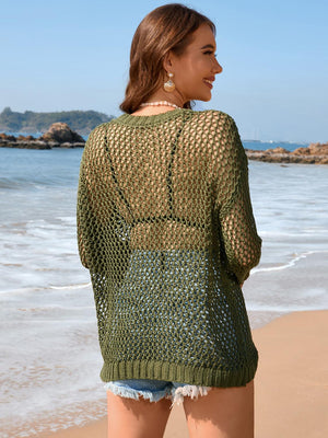 a woman standing on a beach next to the ocean