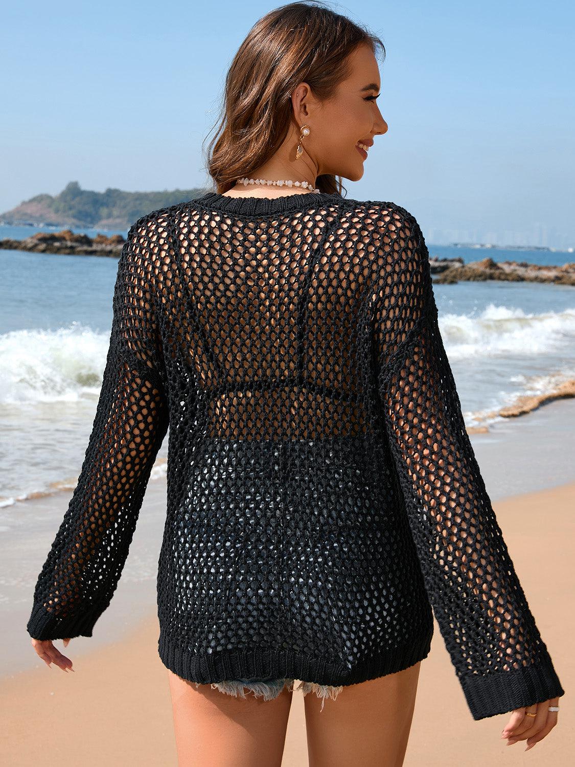 a woman walking along a beach next to the ocean