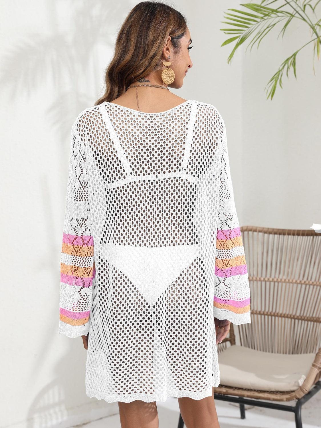 a woman wearing a white crochet cover up