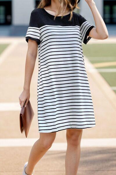 a woman in a black and white striped dress