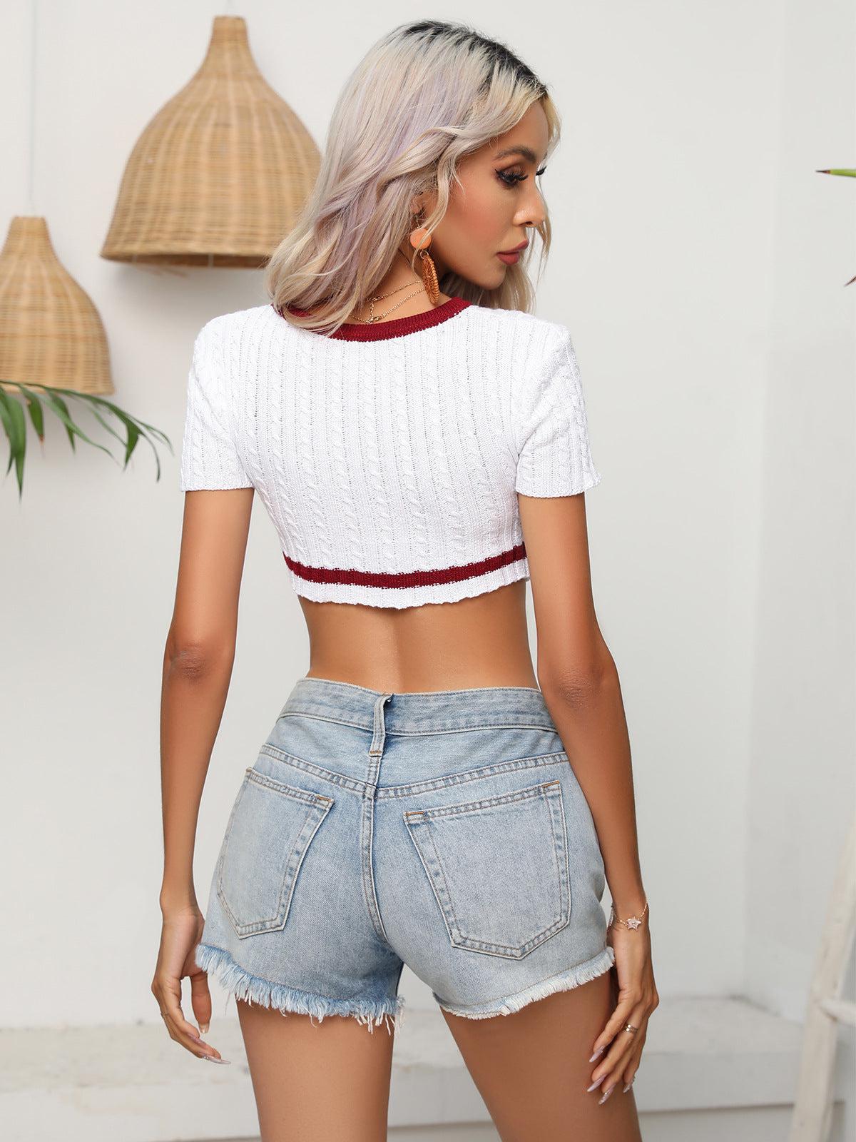 a woman in high waist denim shorts and a crop top