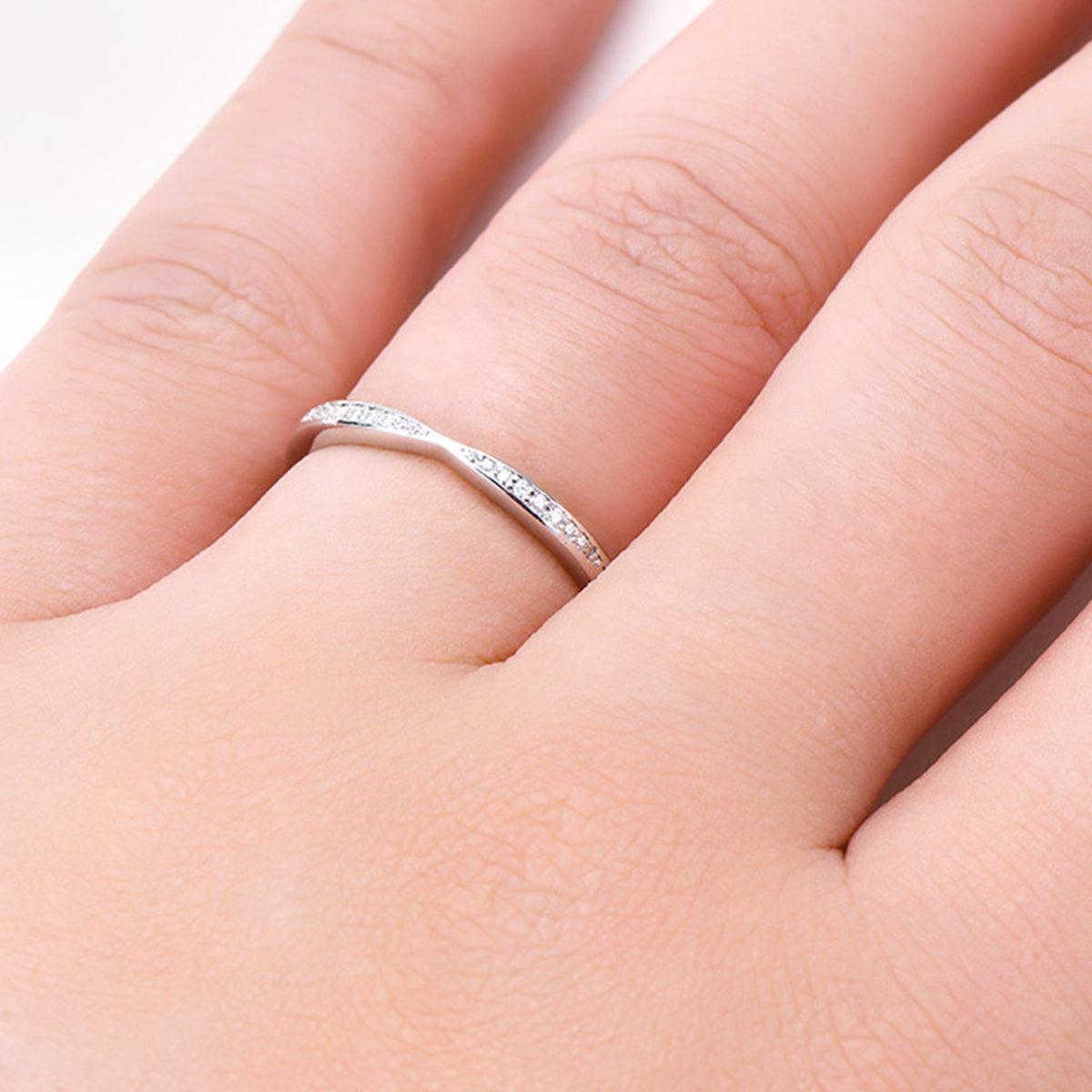 a close up of a person's hand with a ring on it