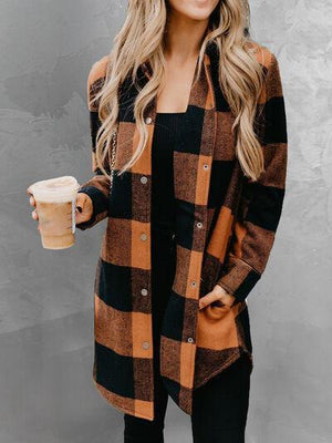 a woman wearing a brown and black checkered coat