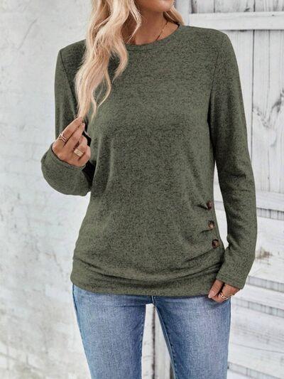 a woman wearing a green sweater and jeans